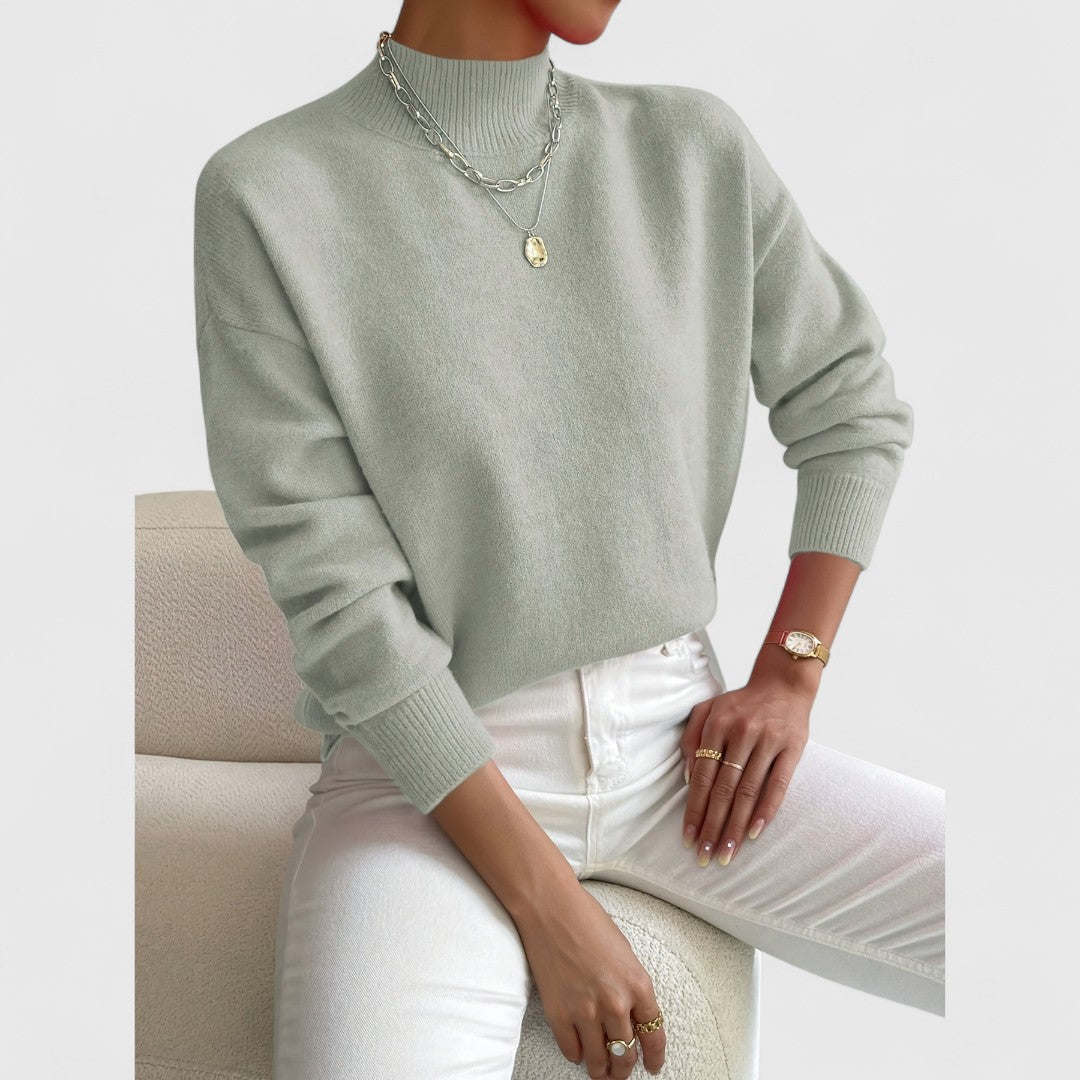 Women's sweater in sage green, another view showing the soft knit texture and ribbed cuffs.