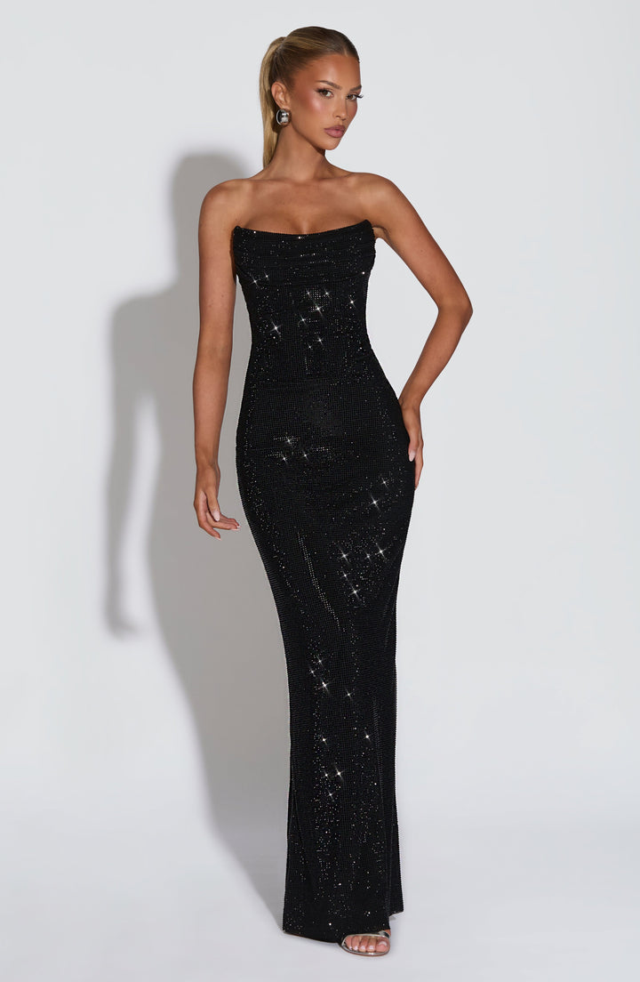 Model wearing the black strapless rhinestone maxi dress, front view, with one hand on her hip 22