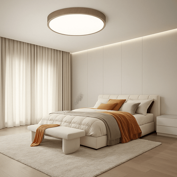 Round wood-finish ceiling light above a bed in a calm bedroom.