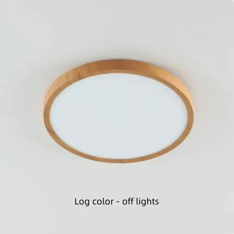 Light log-color wood-finish round light switched off on a pale ceiling.