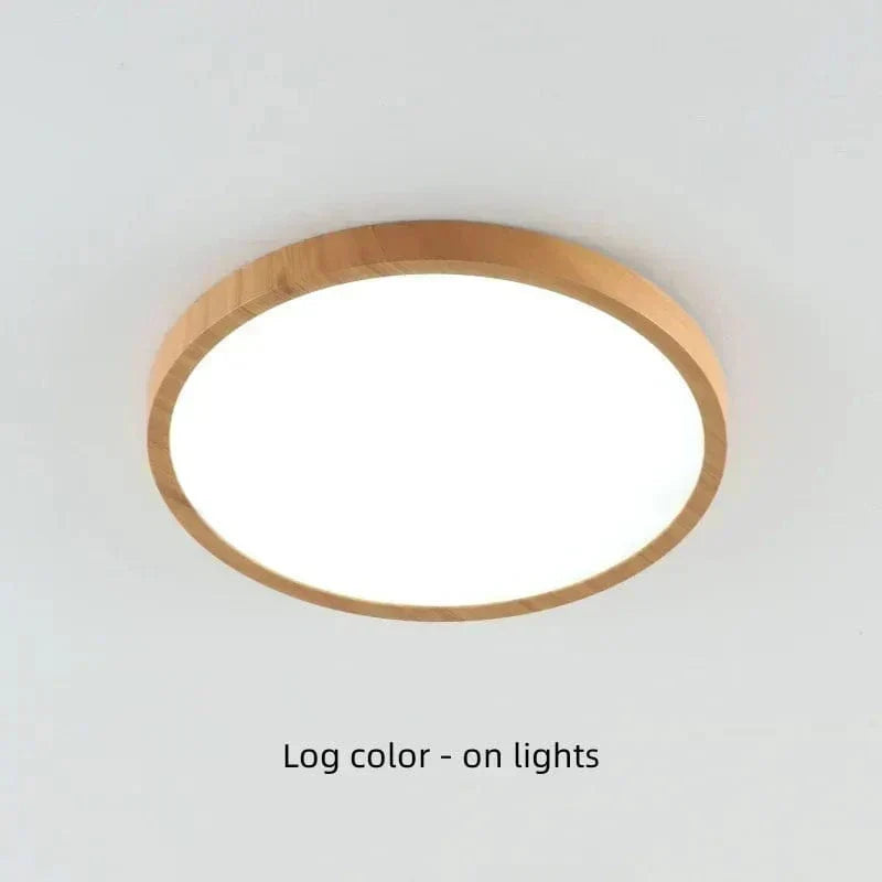 Light log-color wood-finish round light switched on, glowing bright white on a pale ceiling.