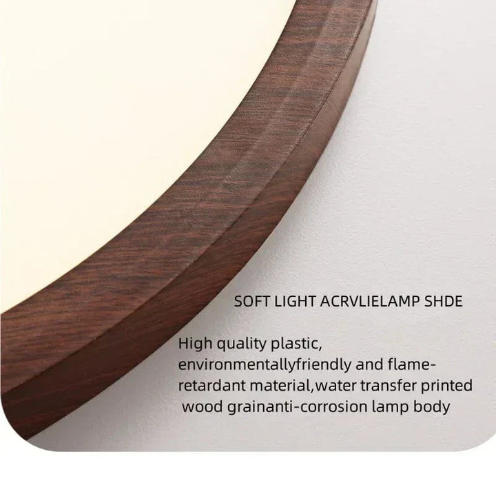 Close-up of the curved edge of the ceiling light, showing the dark walnut wood-grain finish on the slim frame beside the soft white diffuser. 21