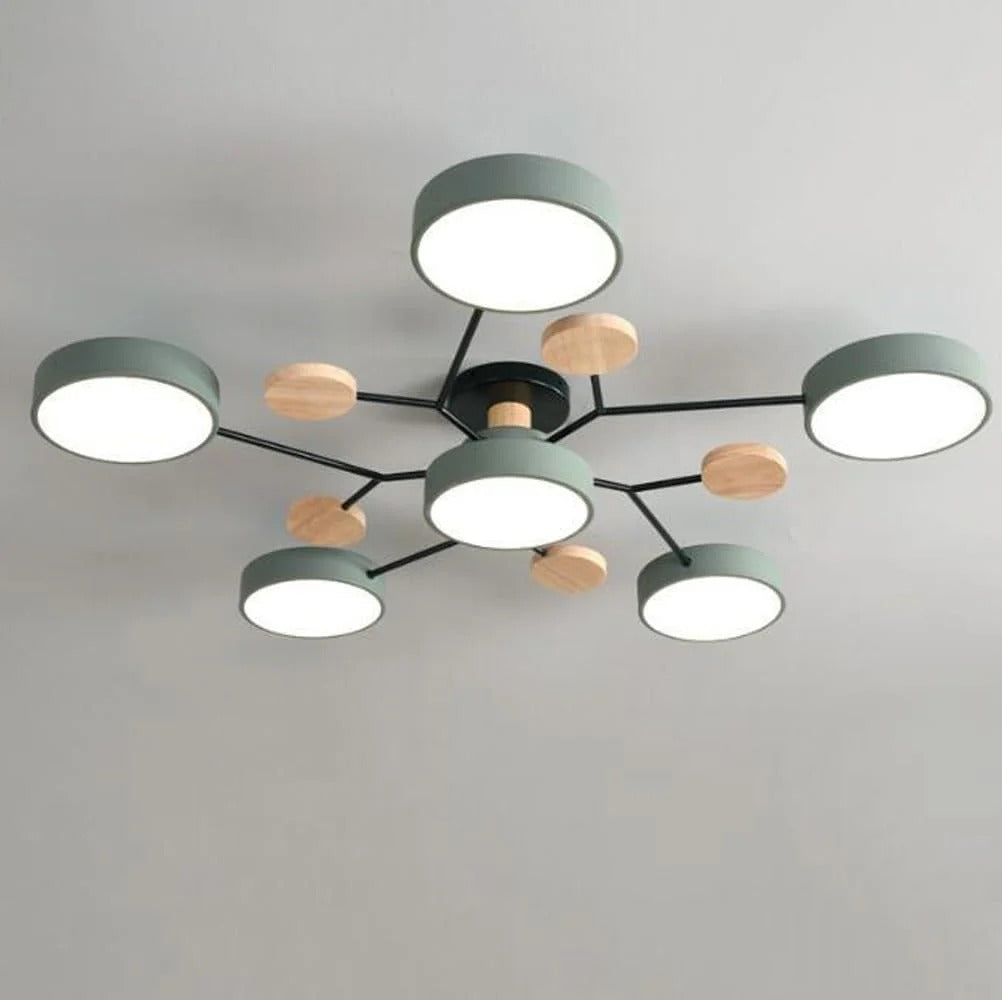 Green seven-light ceiling chandelier with round shades, black arms and small wooden discs, shown close up against a plain gray ceiling. 1