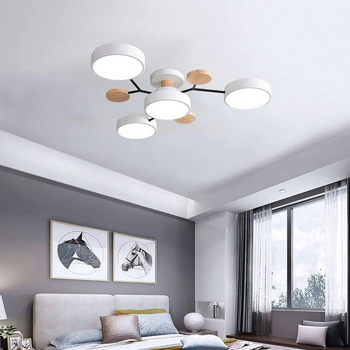 White four-light chandelier above a bedroom with a gray accent wall, light headboard and two horse artworks. 15