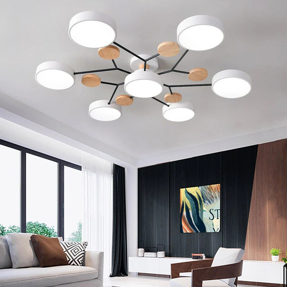 White seven-light chandelier in a living room with a dark wood accent wall, colorful artwork and a white sofa. 18