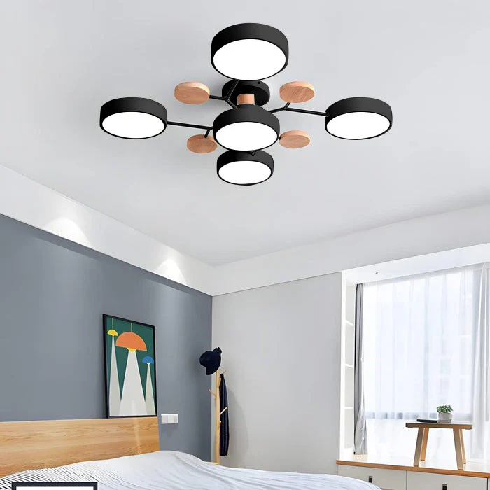 Black five-drum ceiling light with wood discs above a bedroom with a gray accent wall and colorful framed print. 27