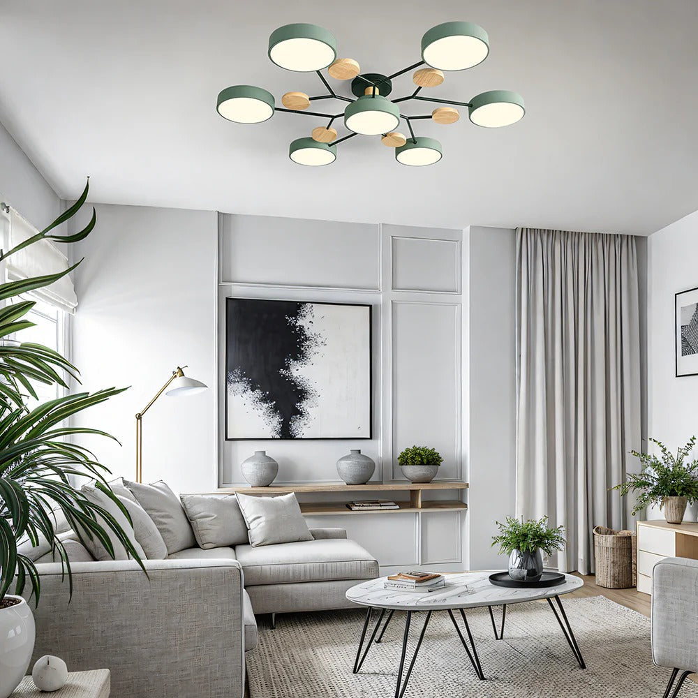 Green seven-light chandelier mounted above a living room with a light gray sectional sofa, marble coffee table and large plants. 3