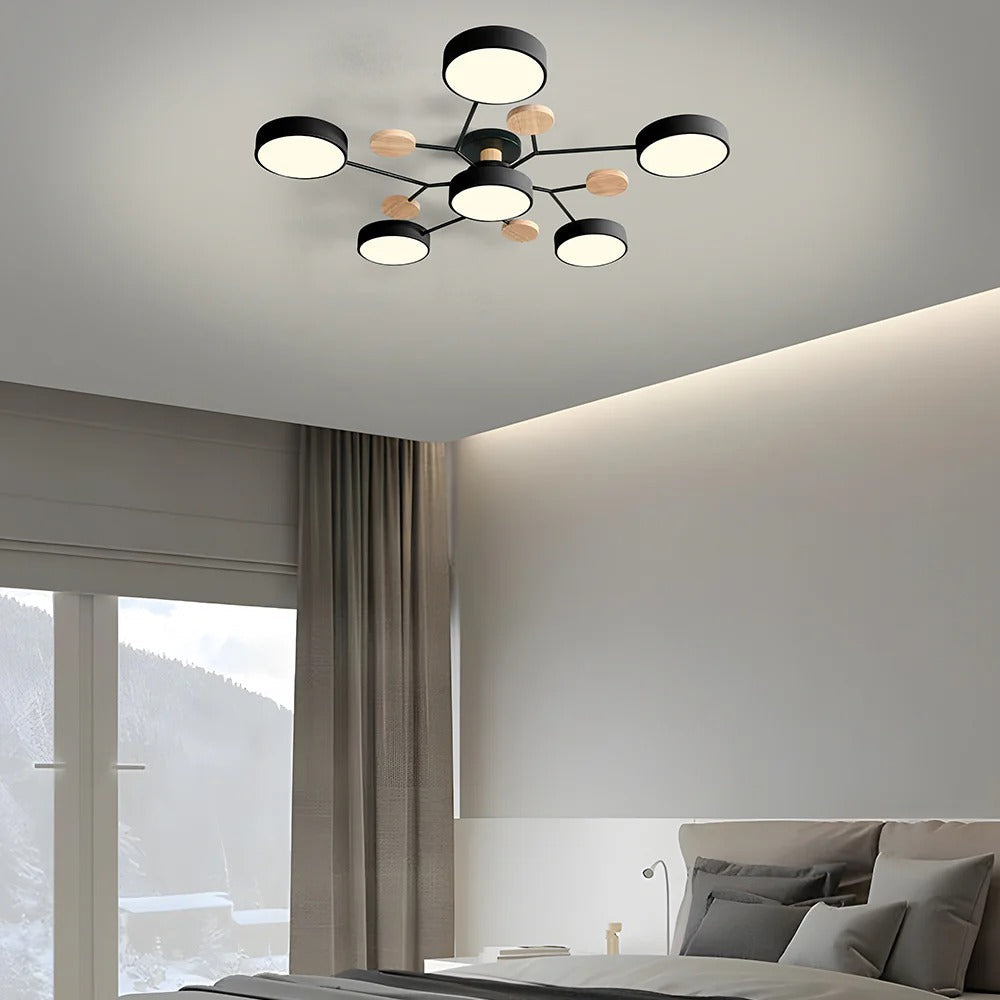 Black six-drum ceiling light above a bedroom with beige curtains, hidden ceiling cove lighting and a snowy window view. 34