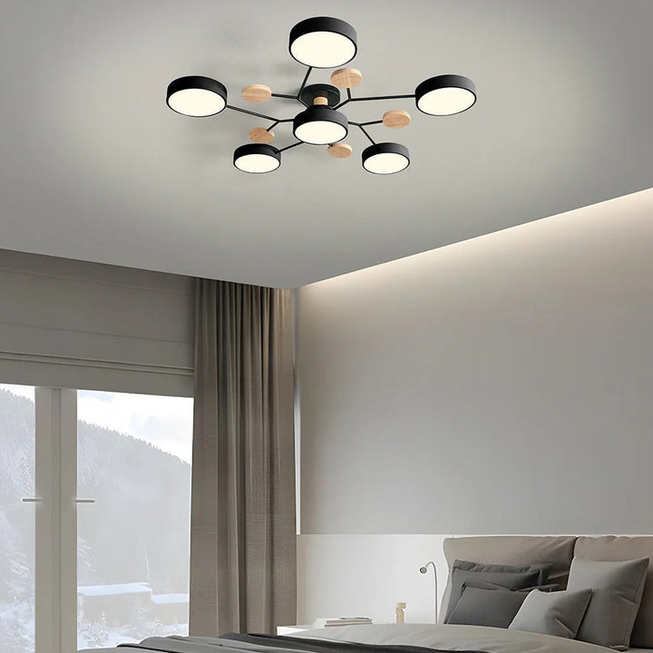 Black six-drum ceiling light above a bedroom with beige curtains, hidden ceiling cove lighting and a snowy window view. 34