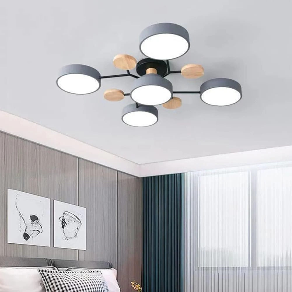 Gray six-light chandelier on a bedroom ceiling above gray wood-paneled walls, framed art and a teal curtain. 8