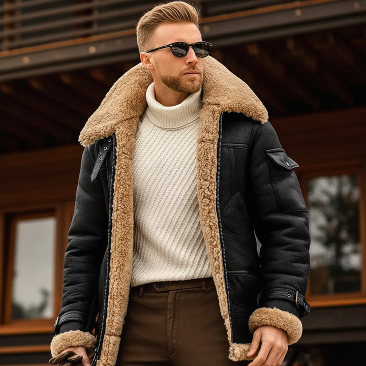Close-up of a man wearing the black jacket with its wide fleece collar, cream turtleneck and sunglasses 2