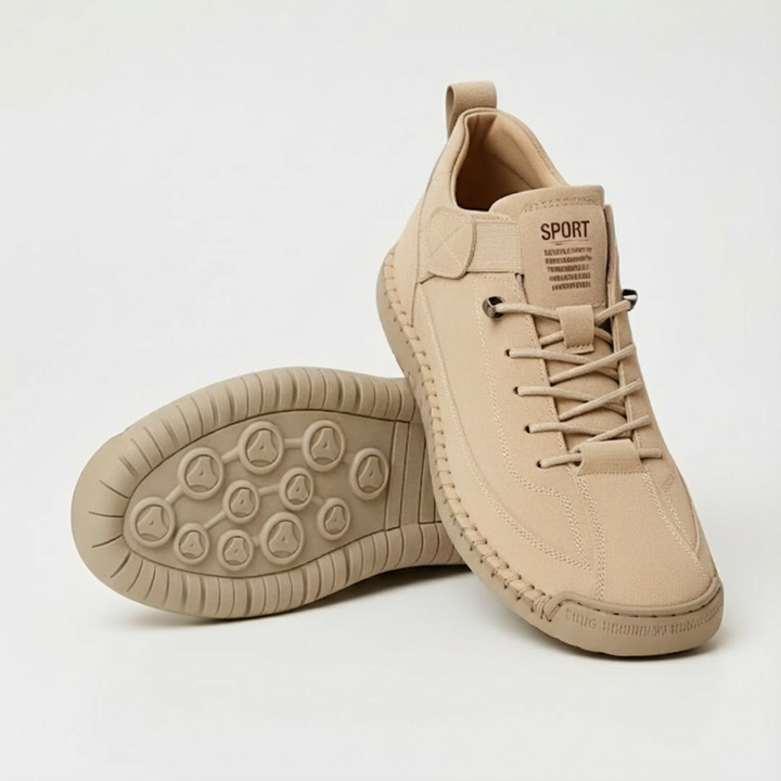 Pair of beige suede-look lace-up sneakers on a light background, one showing its dotted tread sole 1