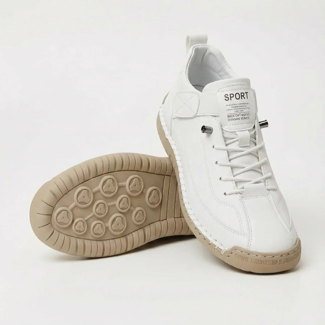 White faux-leather sneakers with elastic laces, one shoe upright and one turned to show the beige sole 2