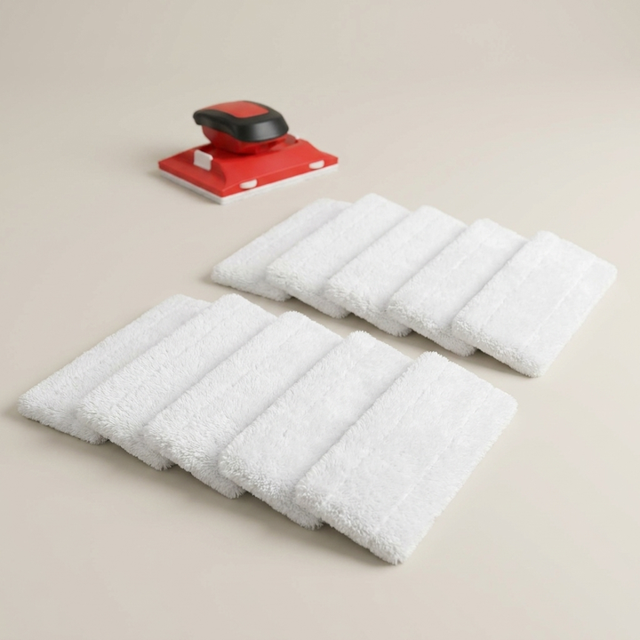 White replacement refill pads and a red edging tool laid out on a beige surface.