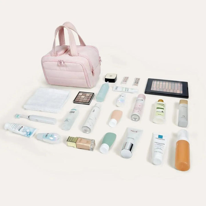Pink toiletry bag shown beside a flat lay of all the skincare, makeup, towel and toothbrush items it can hold. 4