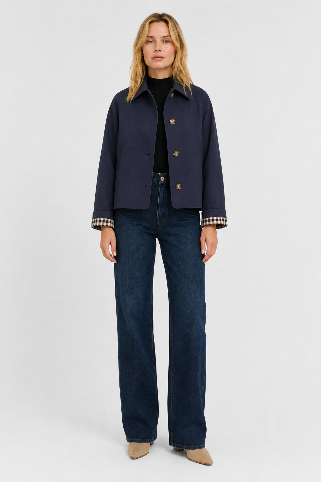 Women's navy blue lightweight jacket, front view buttoned over a black top with dark wide-leg jeans.