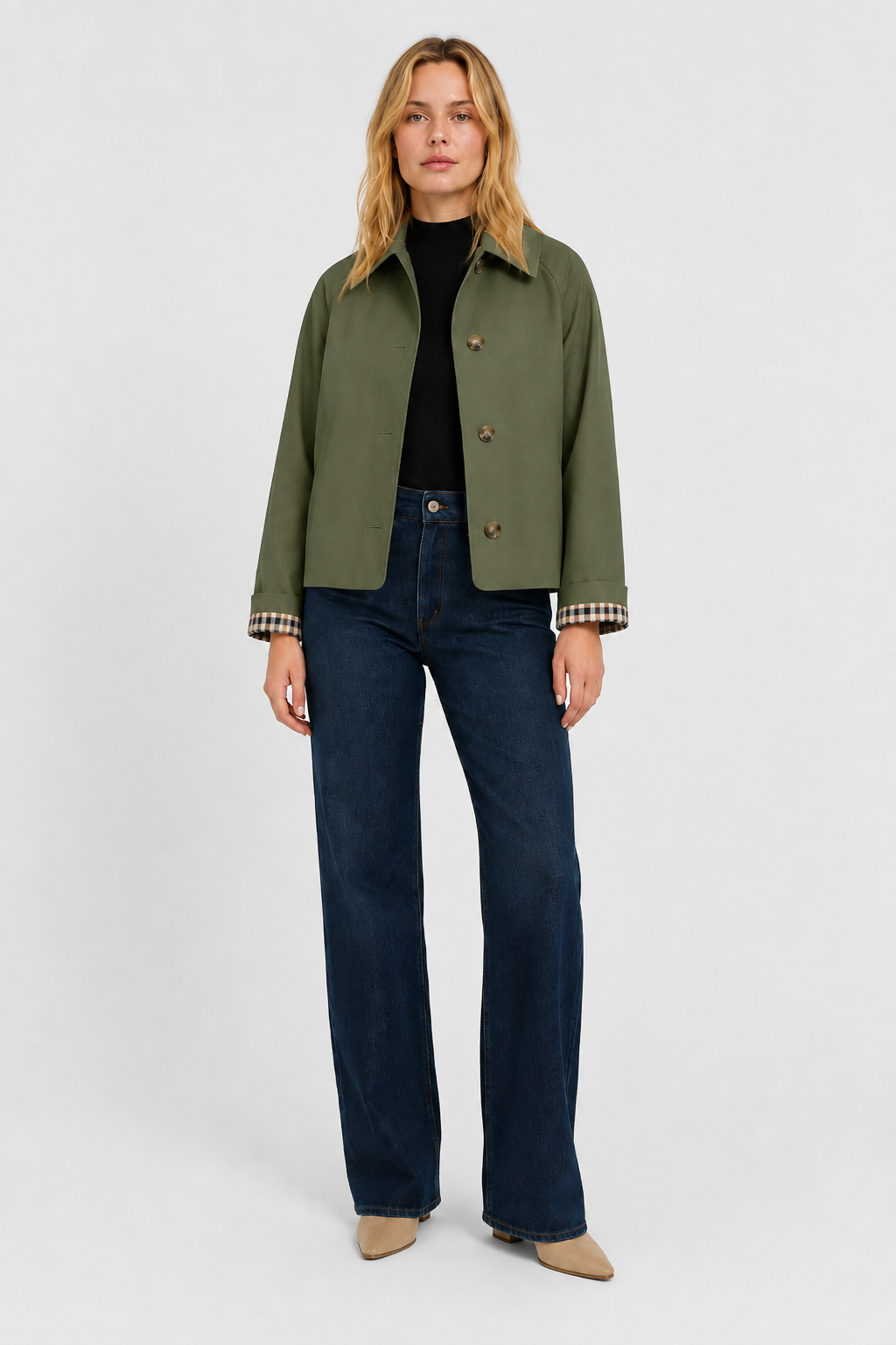 Women's olive green lightweight jacket, front view over a black top with dark wide-leg jeans.