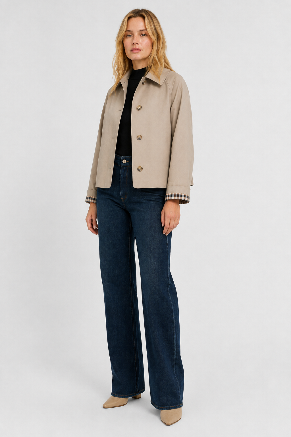 Women's beige lightweight jacket, another view with dark blue wide-leg jeans and pointed beige boots.