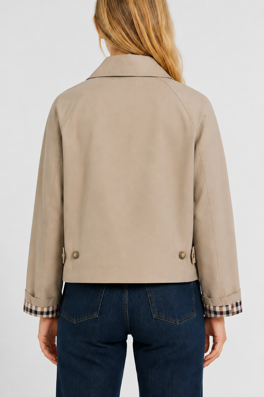 Women's beige lightweight jacket, back view with raglan seams, two buttoned waist tabs and turned-up gingham cuffs.