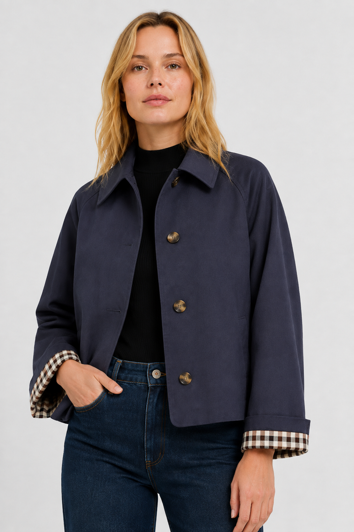 Women's navy blue lightweight jacket with gingham cuff lining, front close-up.