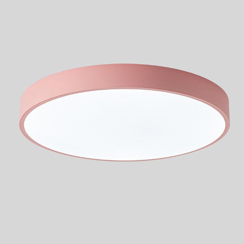 Pink round slim ceiling light with a plain rim and glowing white diffuser, shown alone against a gray background.