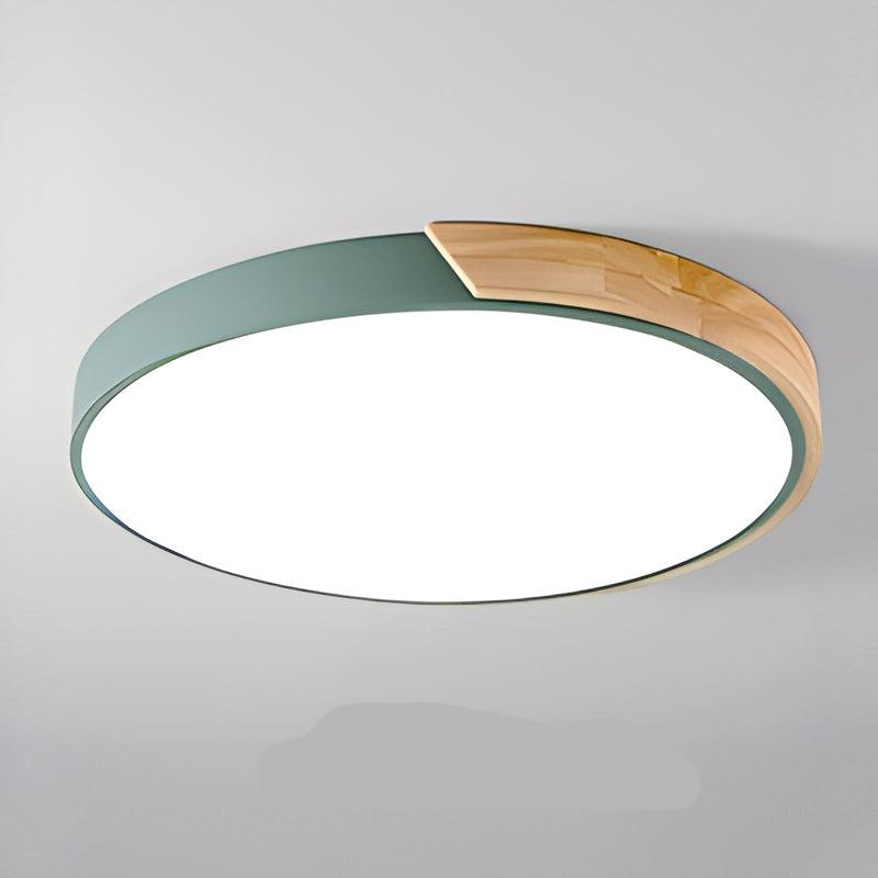 Green round ceiling light with a natural wood segment on the rim and bright white diffuser, product shot on a gray background.
