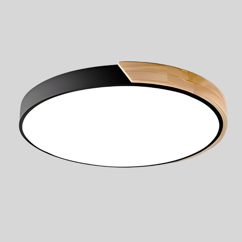 Black round ceiling light with a natural wood segment on the rim and bright white diffuser, product shot on a gray background.