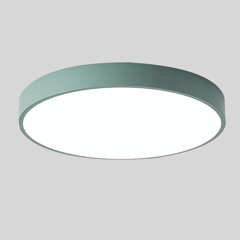 Green round slim ceiling light with a plain rim and glowing white diffuser, shown alone against a gray background.