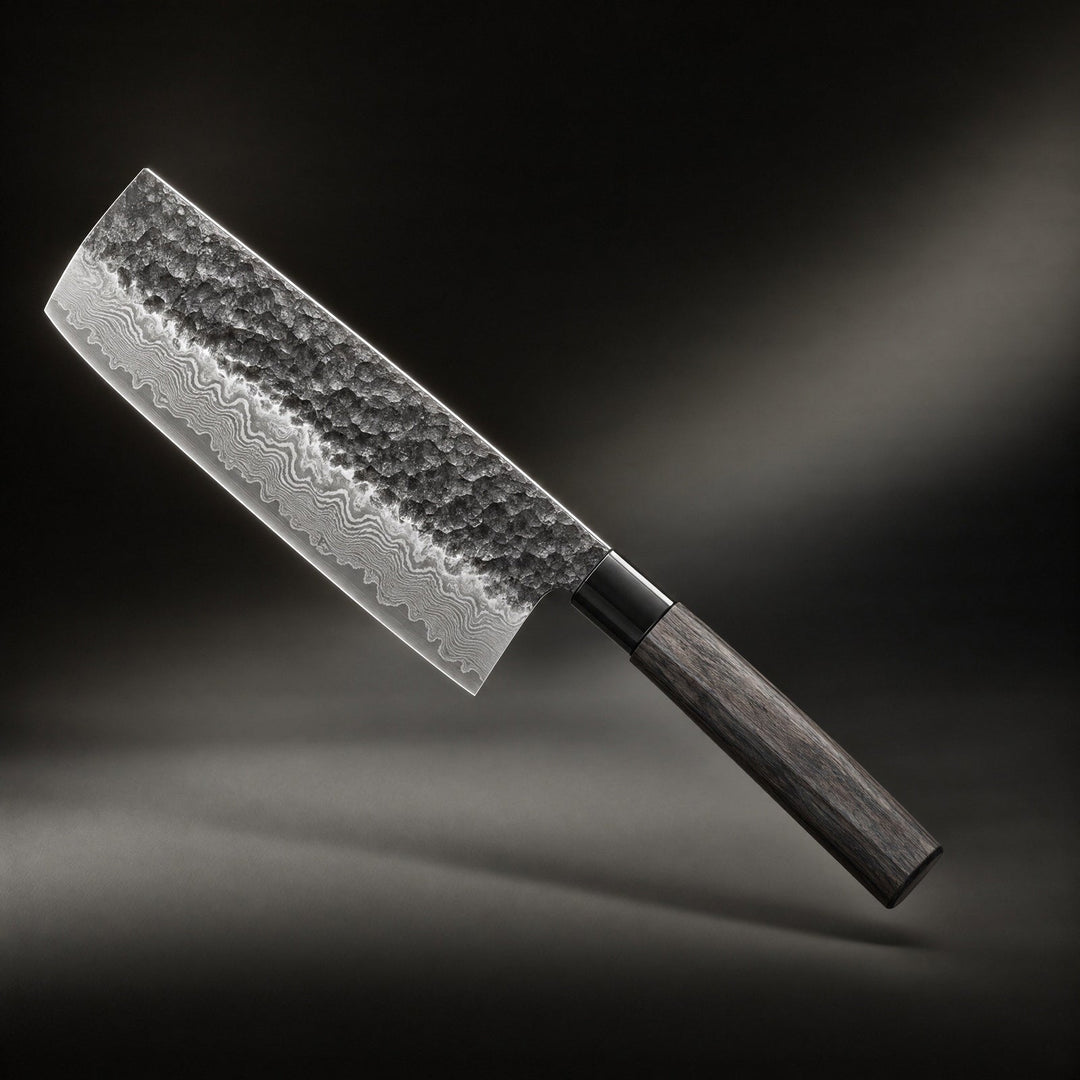 Japanese-style chef's knife with hammered layered steel blade and dark wood handle against a dark backdrop.