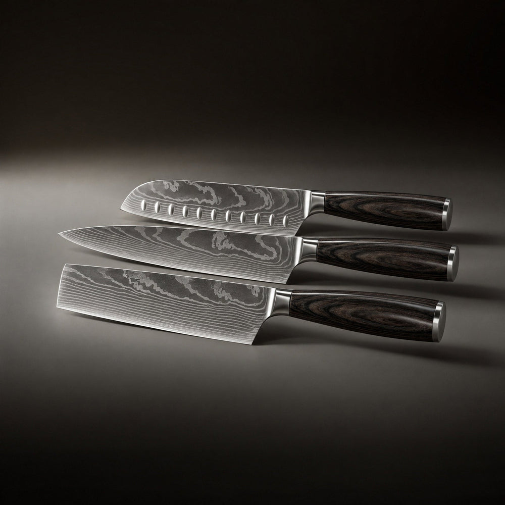 Three knives laid flat side by side, showing the dimpled santoku, the chef's knife and the rectangular blade.