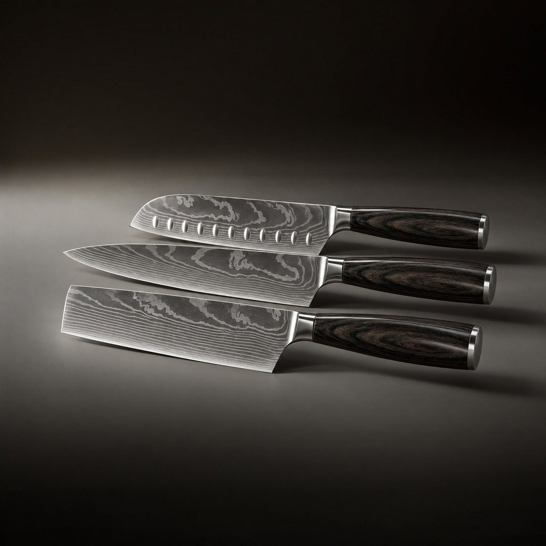 Three knives laid flat side by side, showing the dimpled santoku, the chef's knife and the rectangular blade.