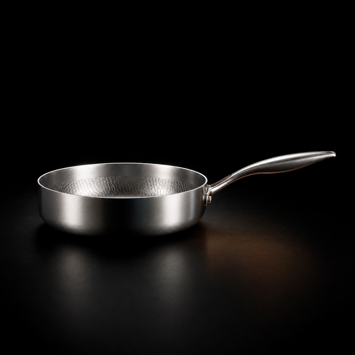 Another view of the silver Hand-Hammered High-Wall Titanium Frying Pan showing the tall straight walls and riveted handle.