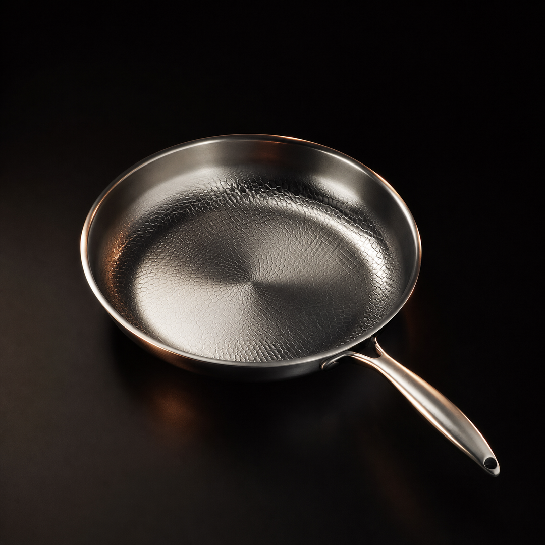 Another view of a single silver hammered metal frying pan with a long brushed handle.