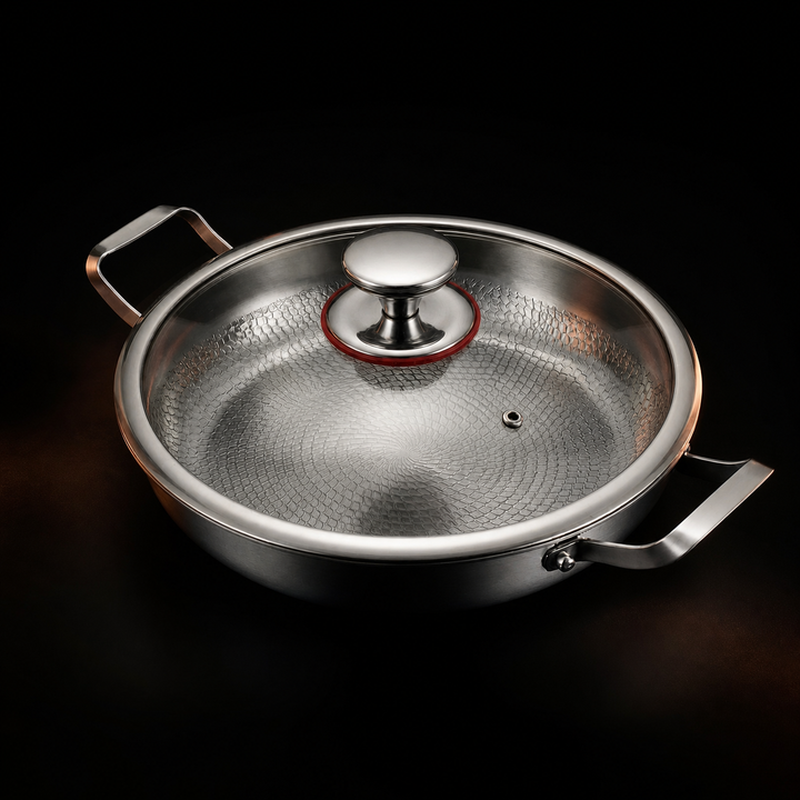 Hammered titanium pan with a clear glass lid and metal knob, detail