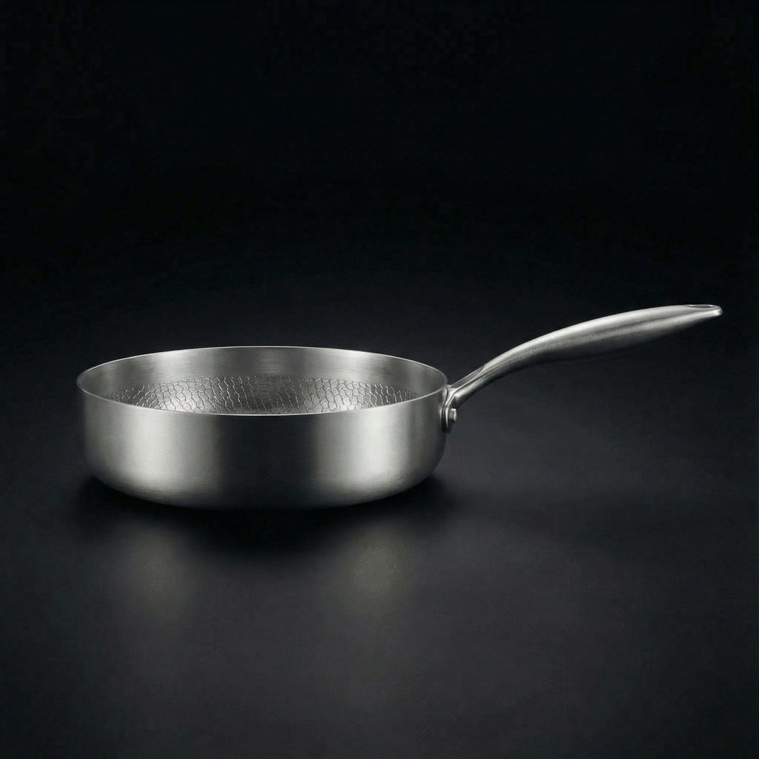 Detail of the deep sauté pan with a long handle and textured interior.