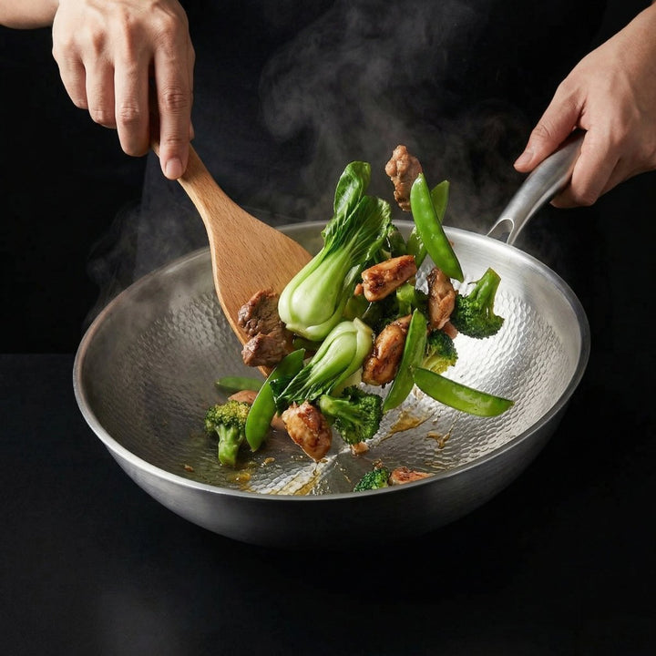 Two hands stir-frying bok choy, broccoli, snap peas and chicken in the wok with a wooden spatula, steam rising. 7