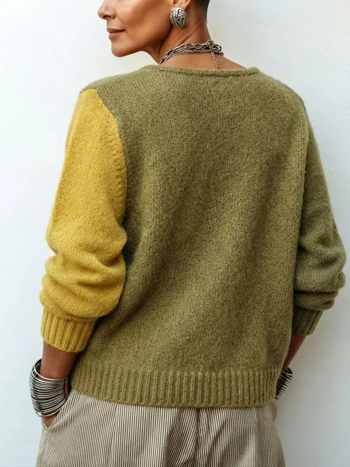 Back view of the sweater showing a solid olive back, mustard left sleeve and ribbed hem 3