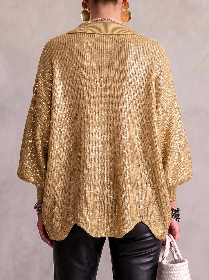 Back view of the gold sequined cardigan on a model, showing the shimmering knit and scalloped back hem. 14