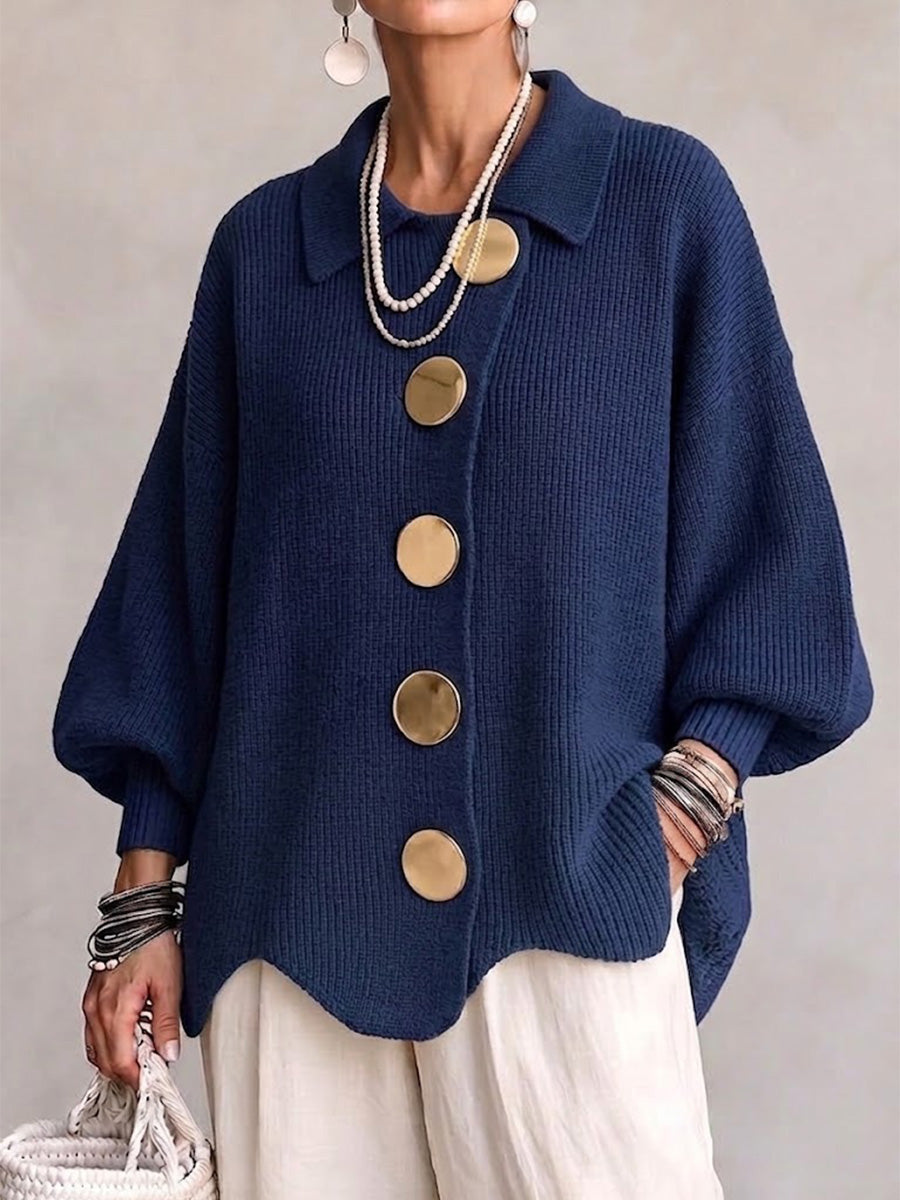 Navy ribbed knit cardigan with large gold buttons on a model.
