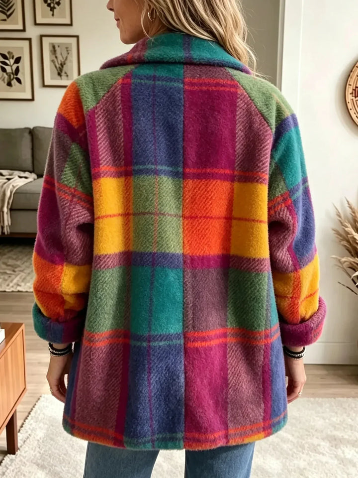 Back view of the fuzzy plaid coat in teal, orange, yellow, magenta and blue, with a collar and cuffed sleeves.