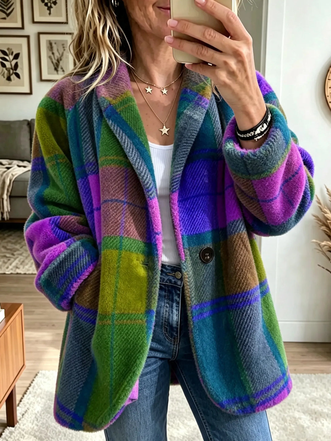 Plaid coat in a purple, green and blue colorway, worn open over a white top and jeans in a mirror selfie.