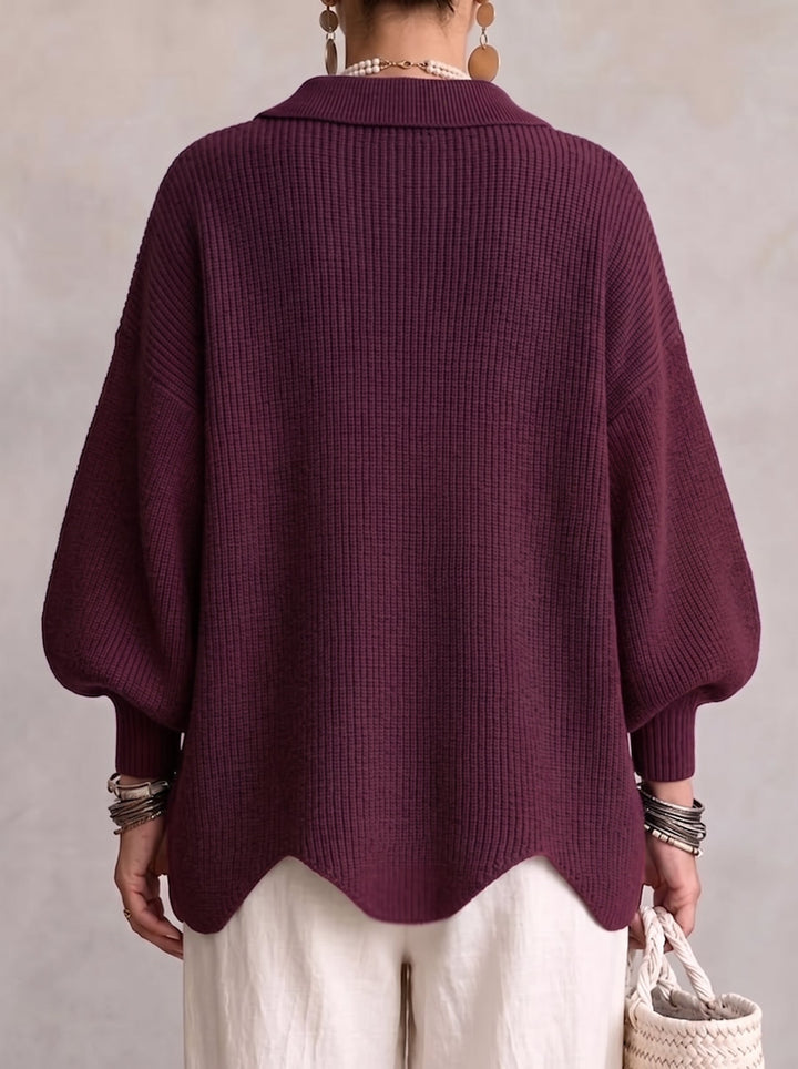 Back view of the plum ribbed cardigan, showing the plain back, folded collar, balloon sleeves and scalloped hem. 15