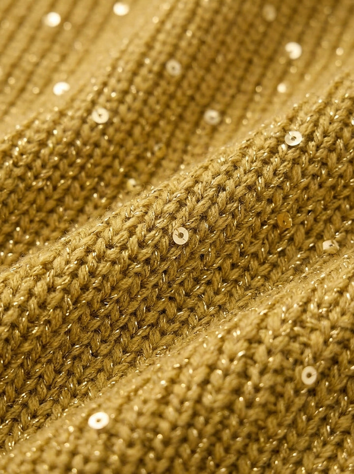 Close-up of gold ribbed knit fabric with small sequins and metallic threads.