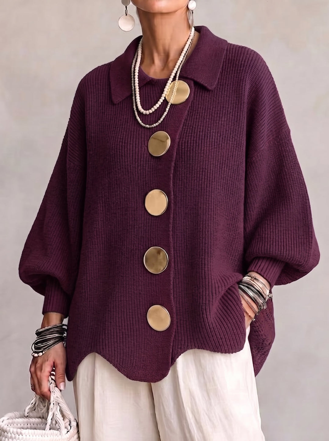 Plum ribbed knit cardigan with large gold buttons on a model.