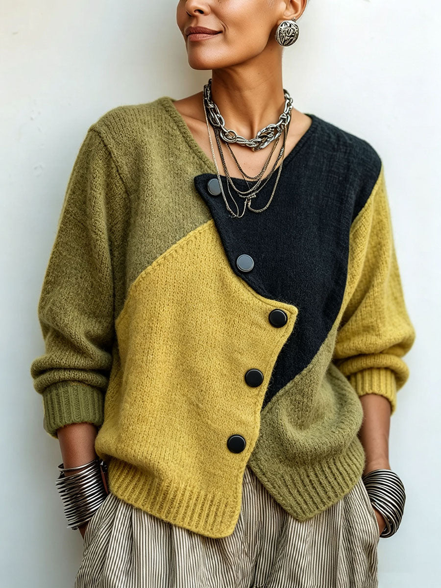 Women's color-block knit sweater with asymmetrical buttons in black, green and yellow, front close-up.