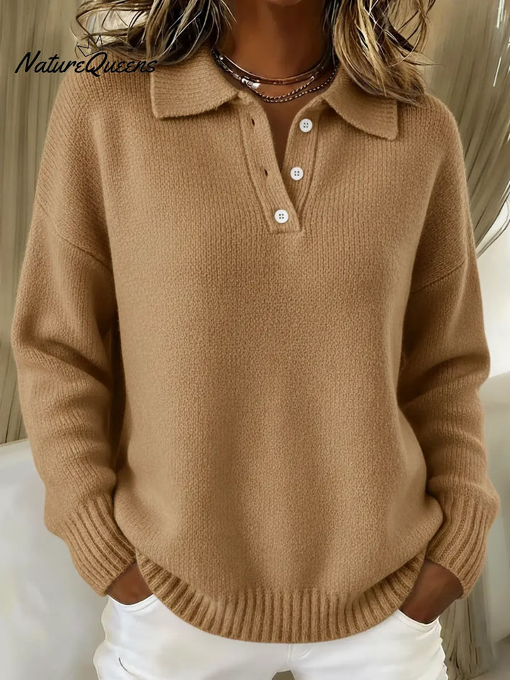 Camel tan polo sweater with a button placket and ribbed hem, styled with white pants.