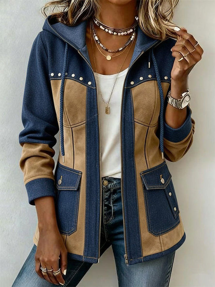 Front view of a woman wearing the unzipped blue denim and tan suede-look hooded jacket over a white top, showing flap pockets and studs.