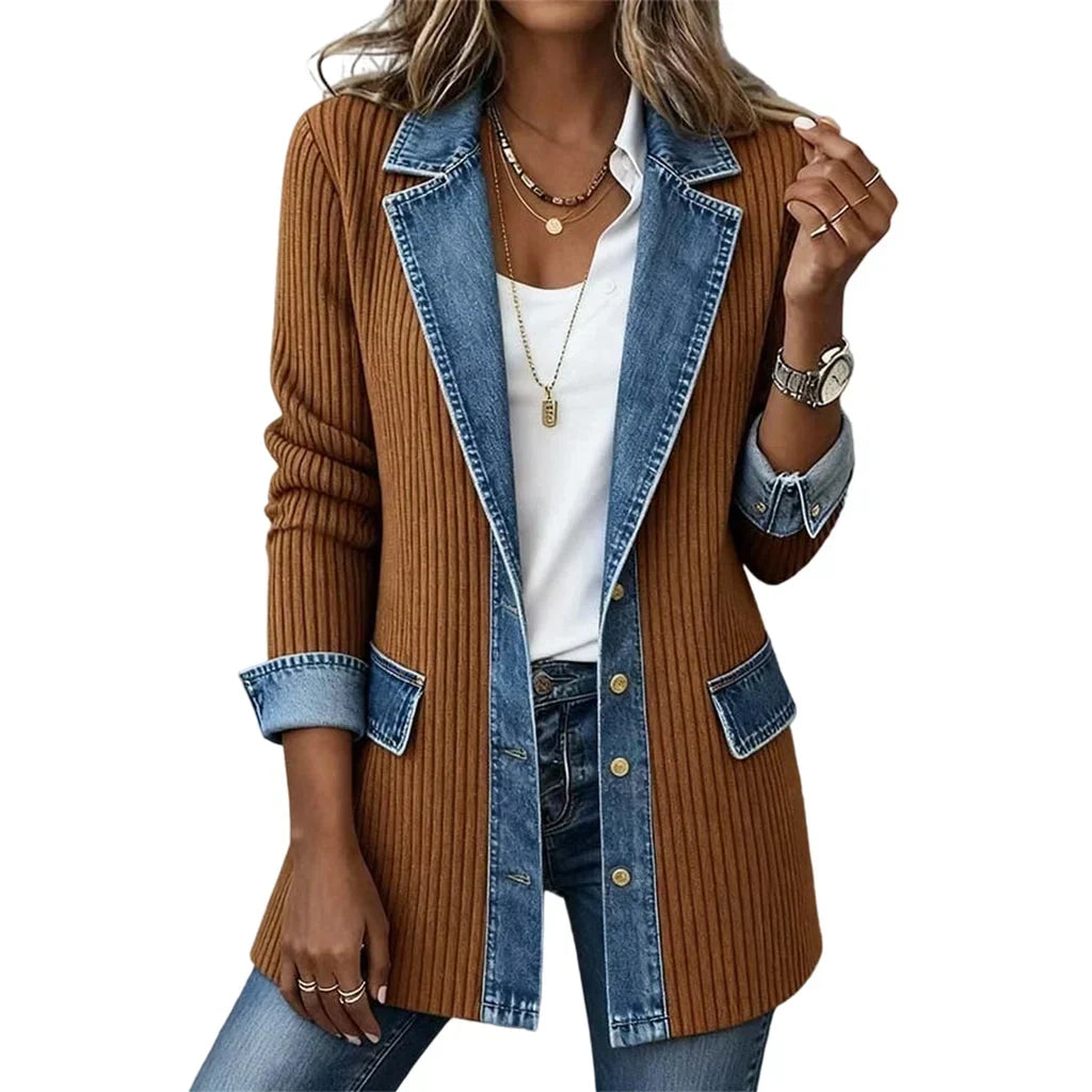 Model wearing the rust brown ribbed coat with denim lapels, flap pockets, cuffs and gold buttons over a white shirt. 14
