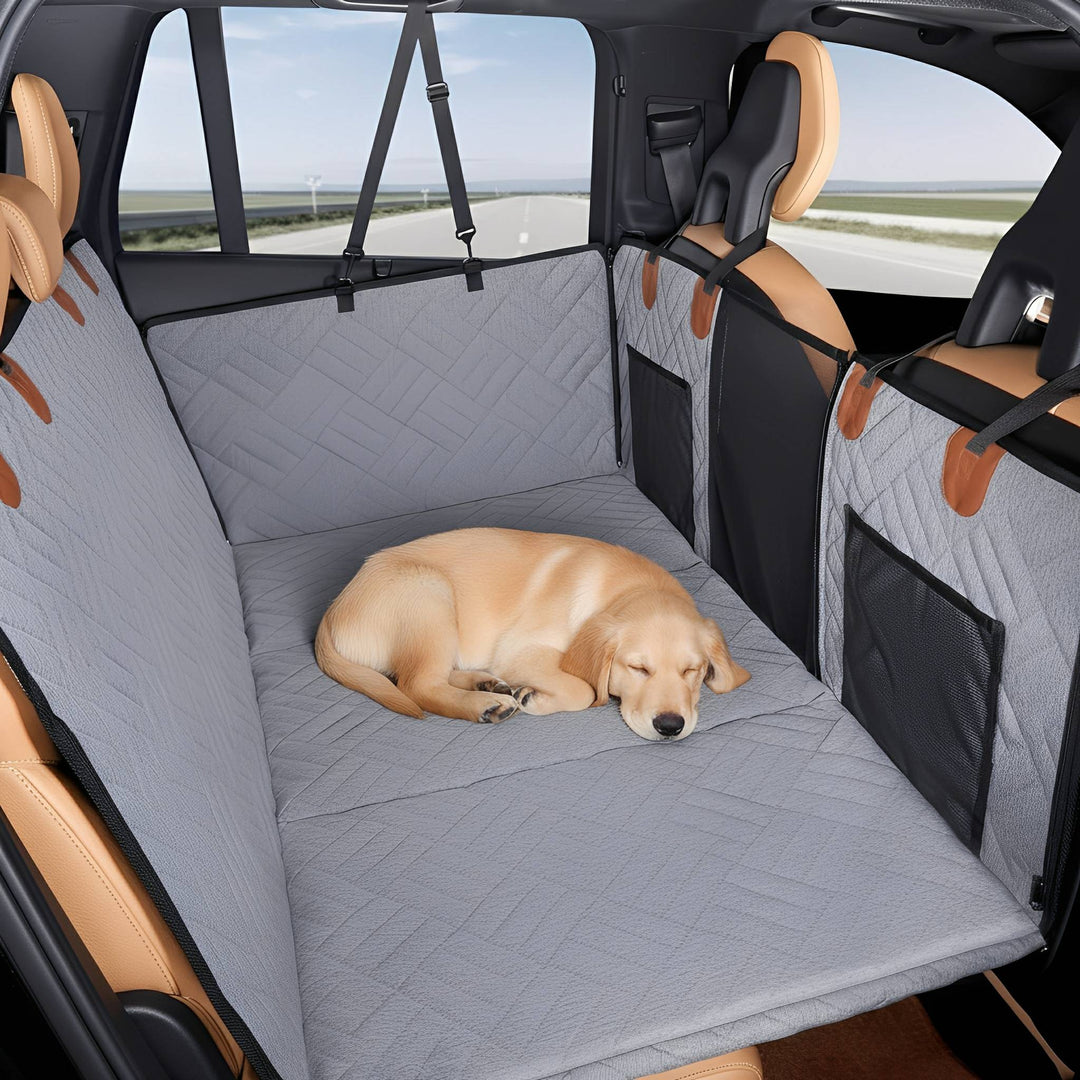 Gray dog back seat extender with a golden dog curled up asleep on the quilted base