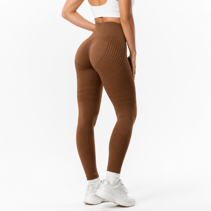 Rear view of brown seamless leggings with curved stripes across the seat, banded thighs, and a ribbed high waistband. 18